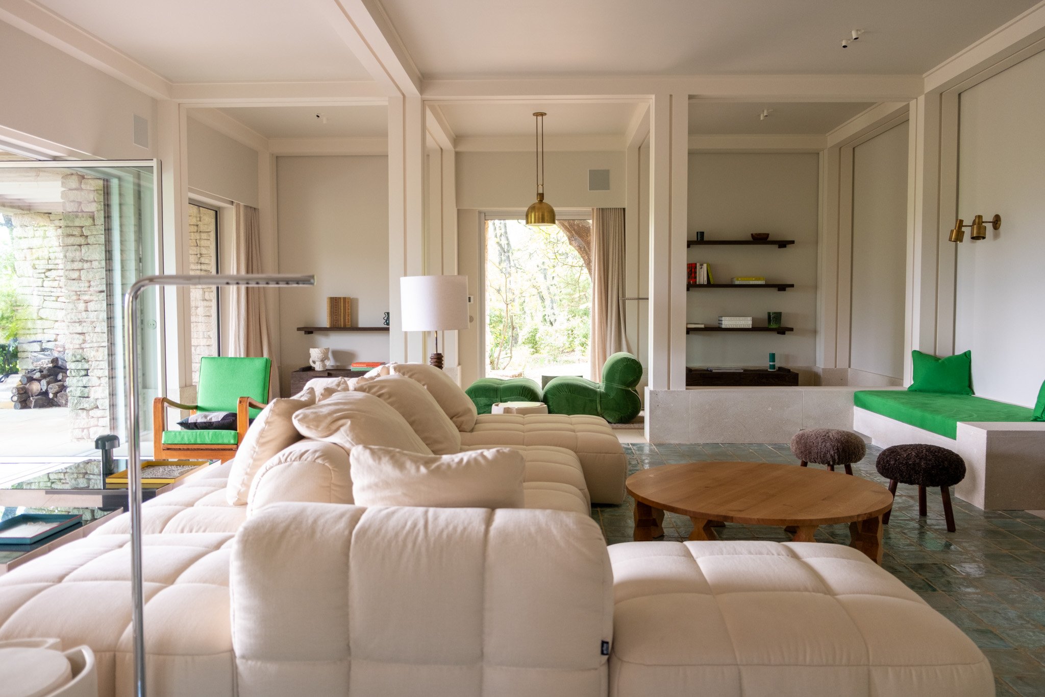 The Bastide Lumiero : Large living room with a double sofa, one side facing the fireplace and the other facing outside.